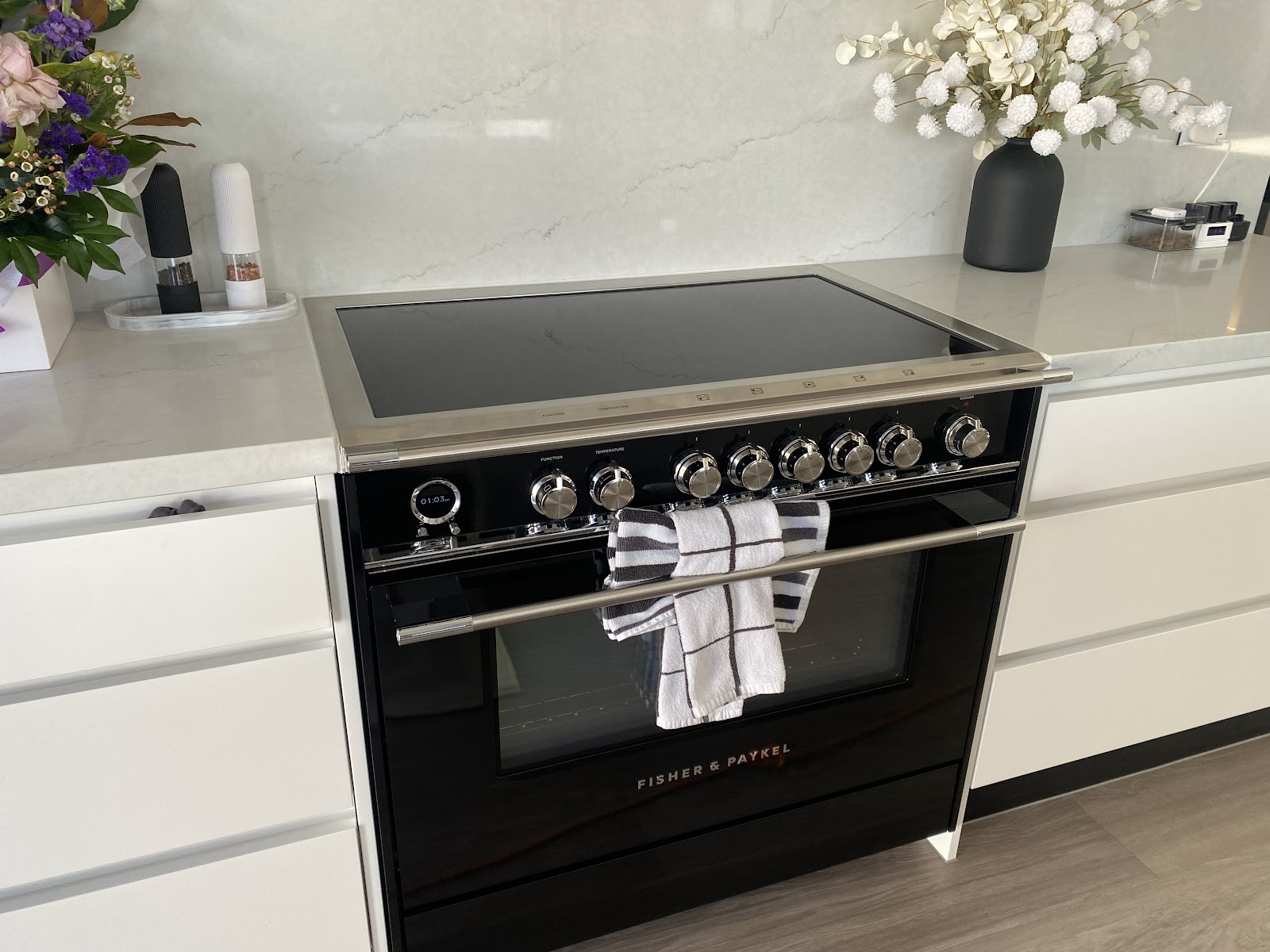 Black freestanding oven and white benchtops wiped clean